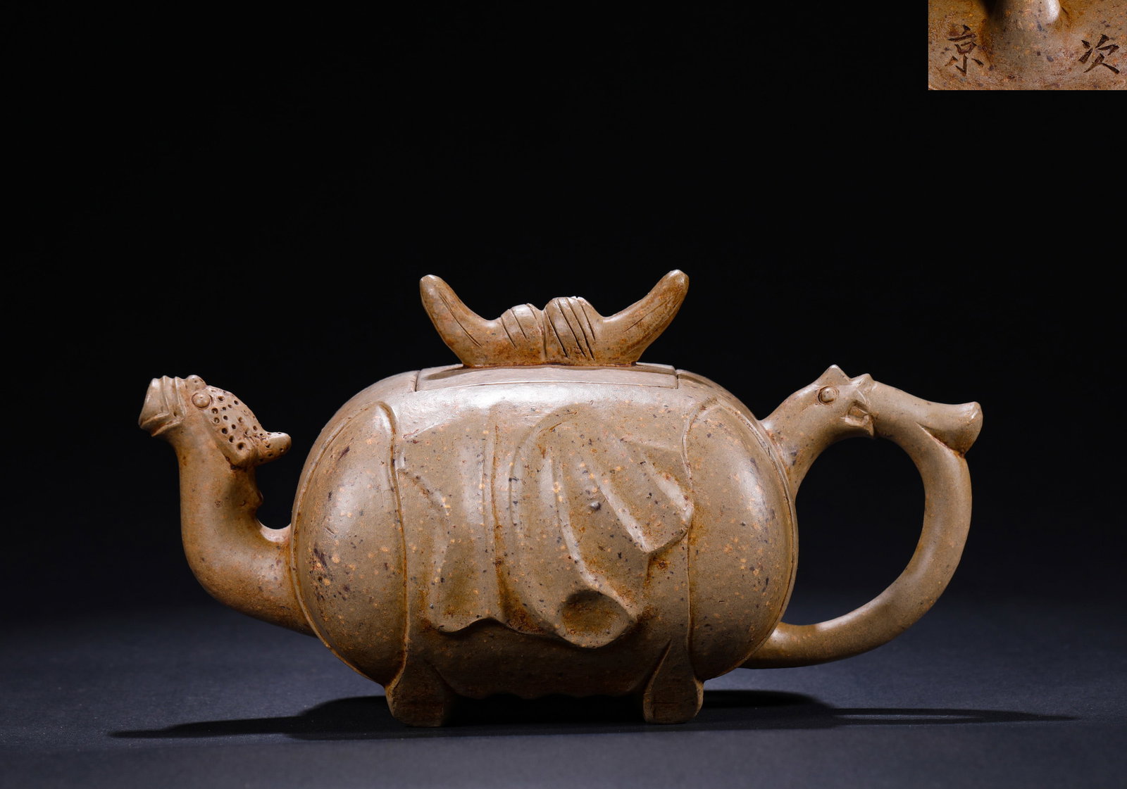 QING DYNASTY BIONIC AUSPICIOUS BEAST PURPLE CLAY TEAPOT: H:11cmW:19cm This is a zoomorphic mythical beast Yixing clay teapot. Made of duan ni (section clay), the body is shaped like a mythical beast's hide, with the spout and handle sculpted into beast head