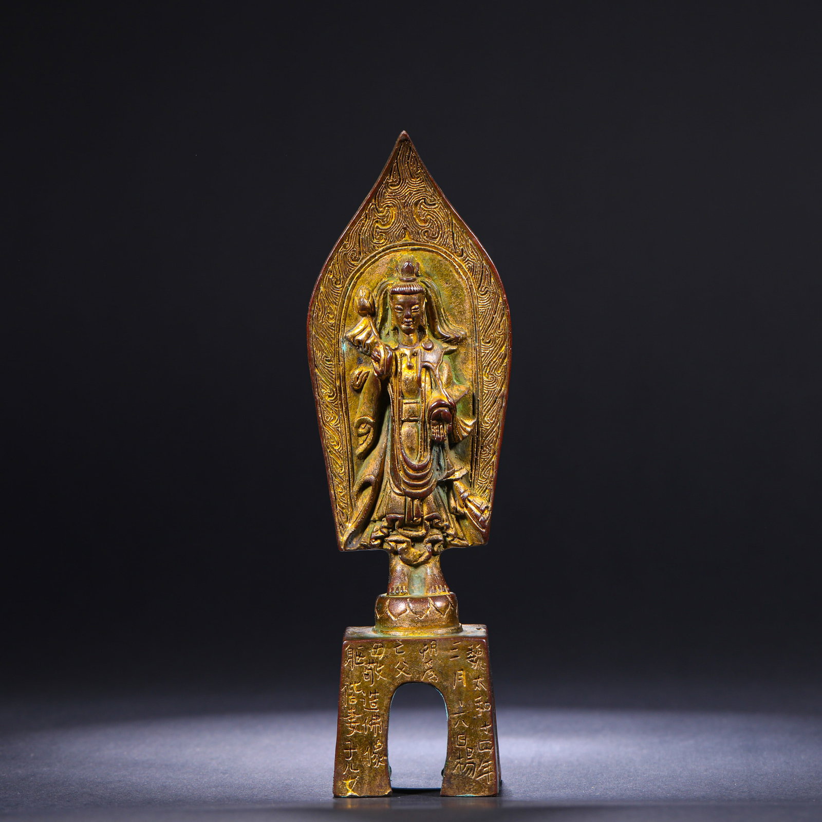 A GILDED BRONZE STATUE OF A BODHISATTVA FROM THE NORTHERN WEI DYNASTY: H:19.5cm(7.68in)W:4.8cm(1.89in)Weight:580g This gilded bronze standing Bodhisattva, dated to the 14th year of Taihe (490 CE) of the Northern Wei Dynasty, has a complete dated votive inscription on its