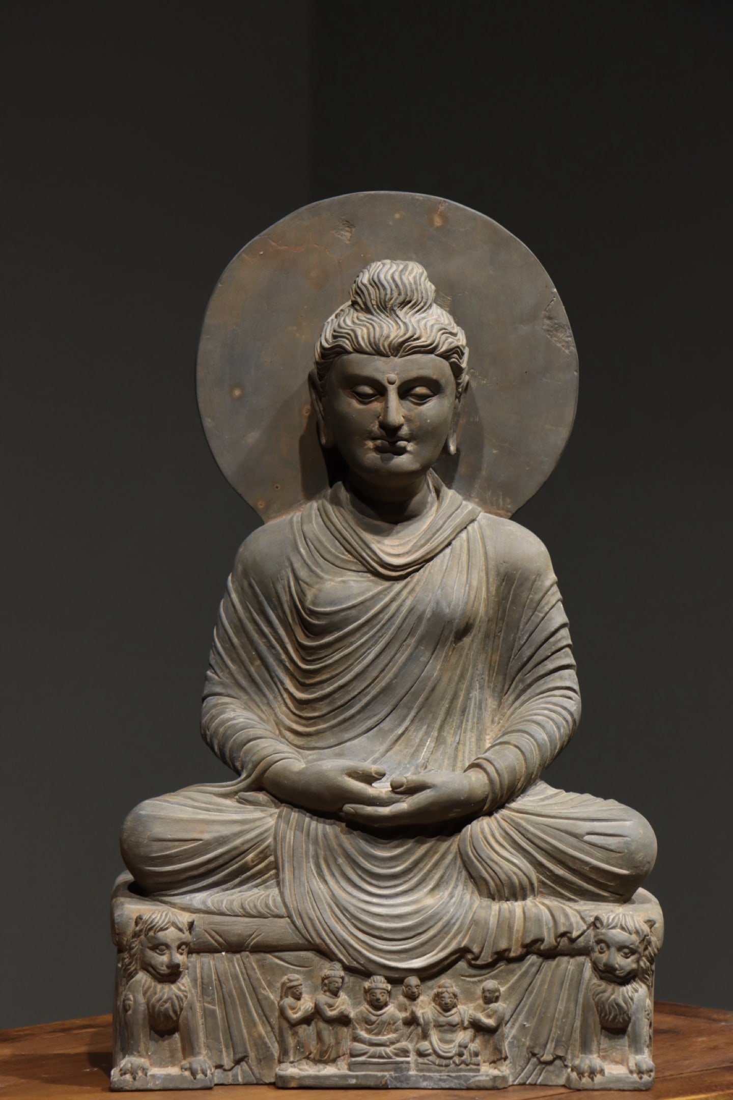 3RD CENTURY GANDHARA BUDDHA STATUES: H:53cmThis is a seated stone statue of Buddha in Gandhara style, depicted in full lotus posture with hands forming the Dhyana Mudra (meditation gesture). It features a circular halo behind and carving