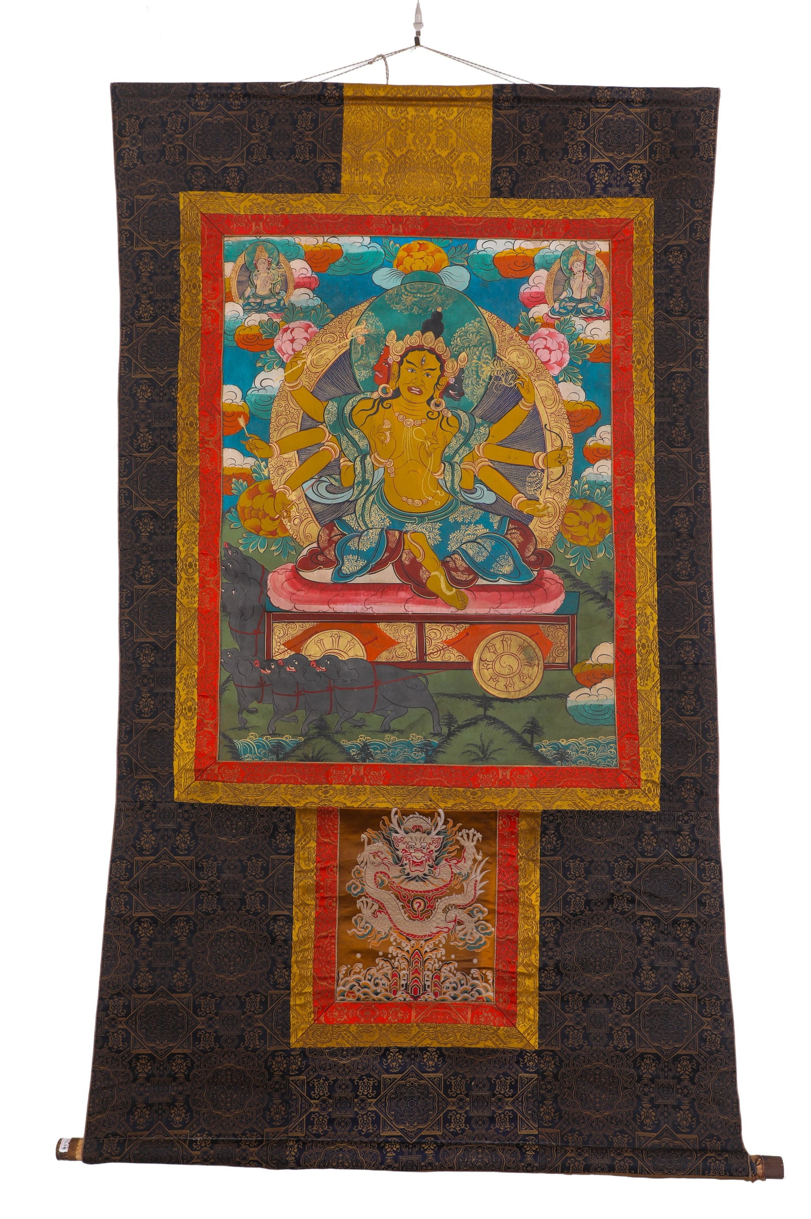 A THANGKA OF THE MAITREYA BUDDHA MOTHER FROM THE QING DYNASTY: H:75cm (29.53in) W:55cm (21.65in)This is a classic Tibetan Buddhist Thangka of Marici, the Goddess of Light. The main deity has three faces and eight golden arms, seated on a chariot pulled by wild bo