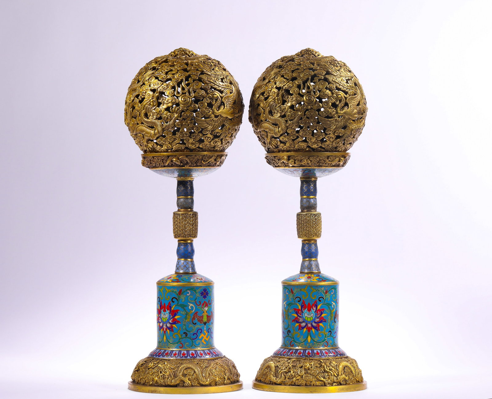 QING DYNASTY COPPER BODY CLOISONNE ENAMEL GILDED DRAGON AND PHOENIX PATTERN OFFICIAL HAT STAND: H:40.0cm(15.75in) W:13.0cm(5.12in) Weight:6130g(13.51lb)This pair of hat stands is a top-tier masterpiece of Qing Dynasty cloisonné craftsmanship. Cast with a bronze body, it features full-body clois