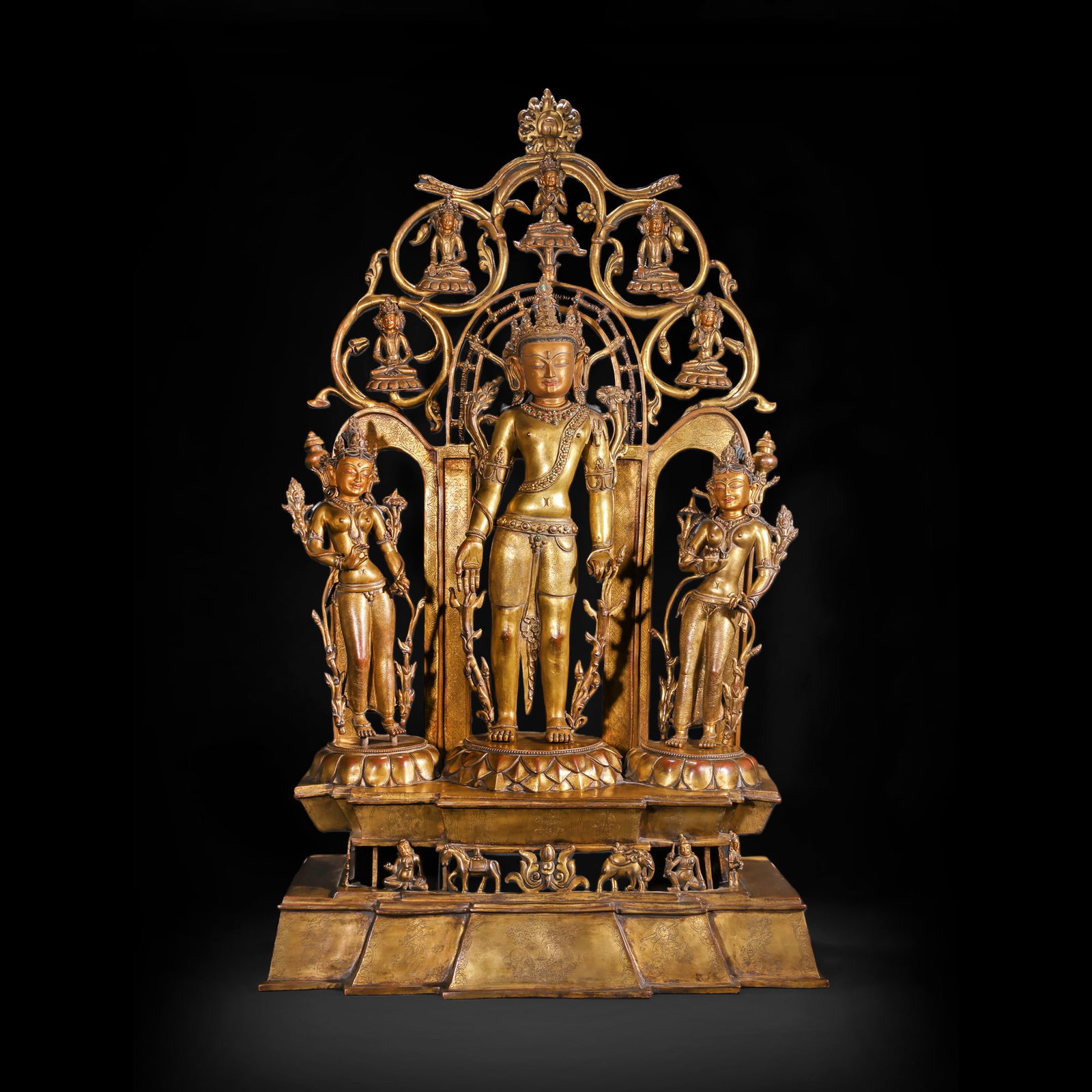 THREE STANDING STATUES OF MAITREYA BODHISATTVA IN GILDED BRONZE FROM THE QING DYNASTY: H:103.0cm(40.55in) W:56.0cm(22.05in) Weight:43000g(94.80lb)This statue is cast in gilded bronze. The main figure is Maitreya Bodhisattva (Buddha of the Future), standing in a relaxed posture on a lotu