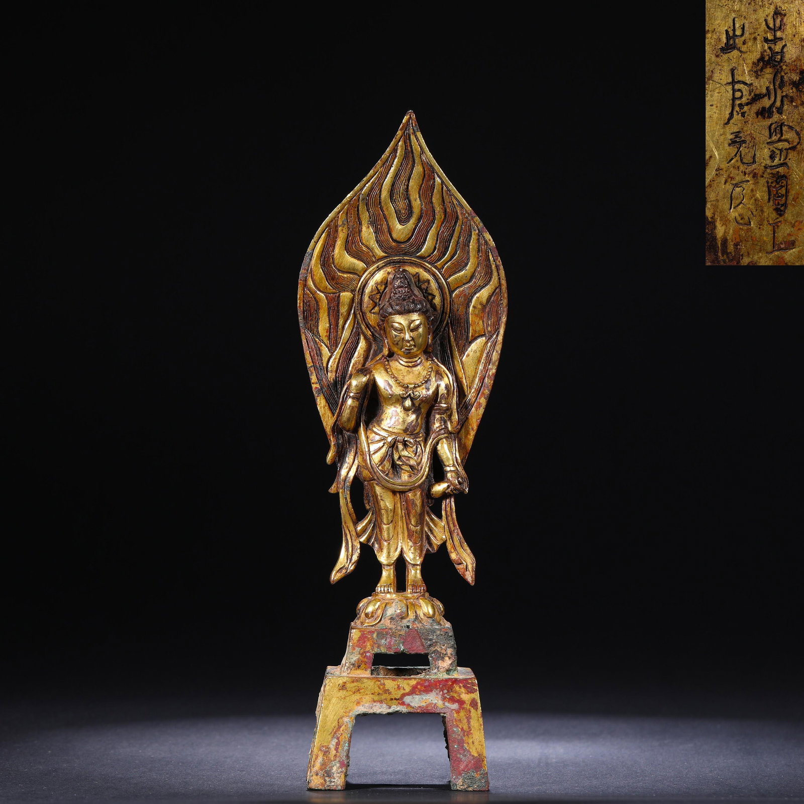 TANG DYNASTY GILDED BRONZE STATUE OF A BODHISATTVA: H:21cm(8.27in)W:5.4cm(2.13in)Weight:550g This is a gilded bronze standing Bodhisattva statue (with a flame-shaped boat-shaped aureole and votive inscription), likely dating from the mid-Tang Dynasty (