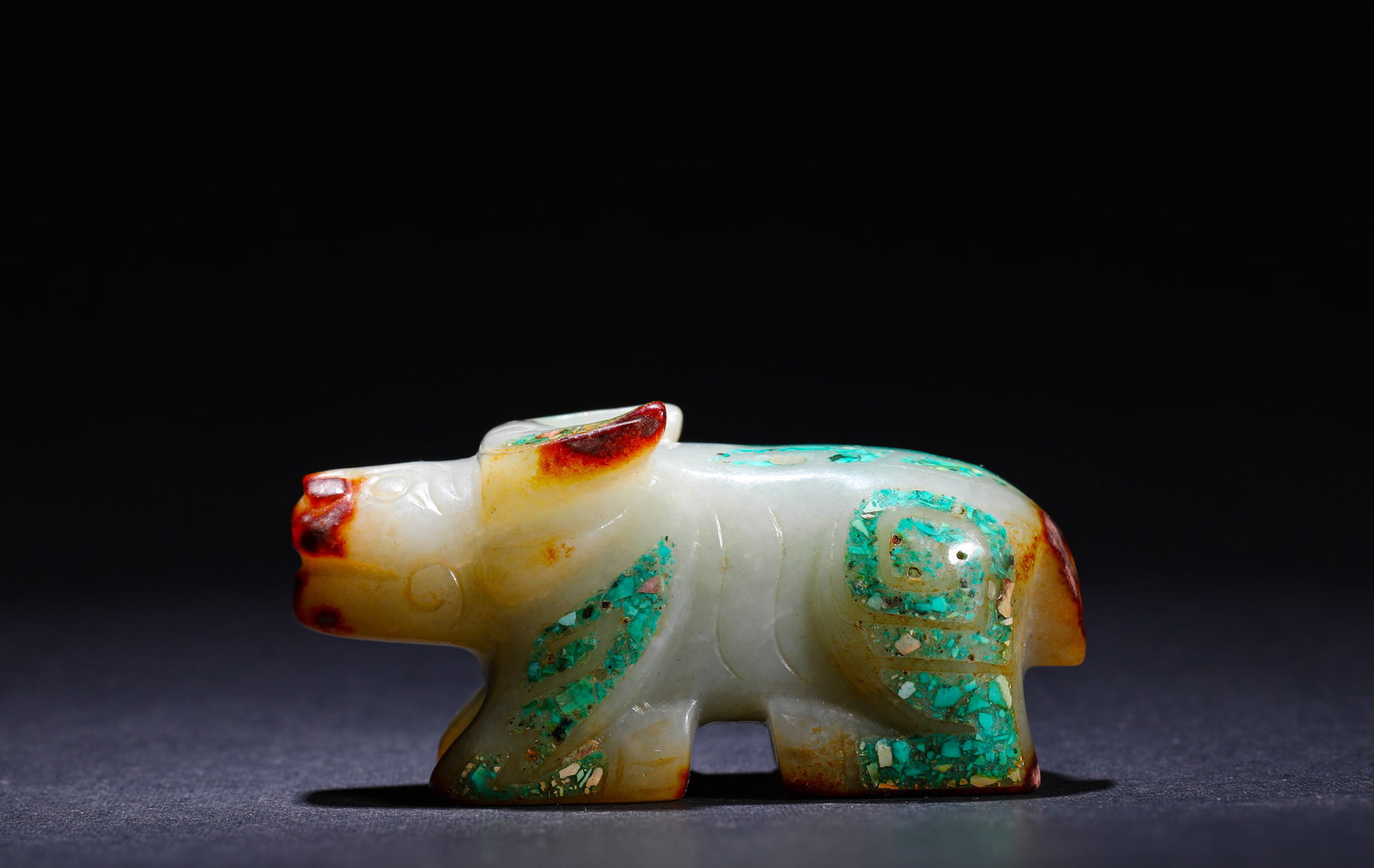 ANCIENT HAN DYNASTY JADE PENDANT INLAID WITH TURQUOISE IN THE SHAPE OF A COW: H:3cm(1.18in) W:6cm(2.36in) Weight:80g(0.18lb)This is an ancient jade ox-shaped pendant inlaid with turquoise, featuring warm calcified jade and exquisite craftsmanship, a precious work of ancient jad