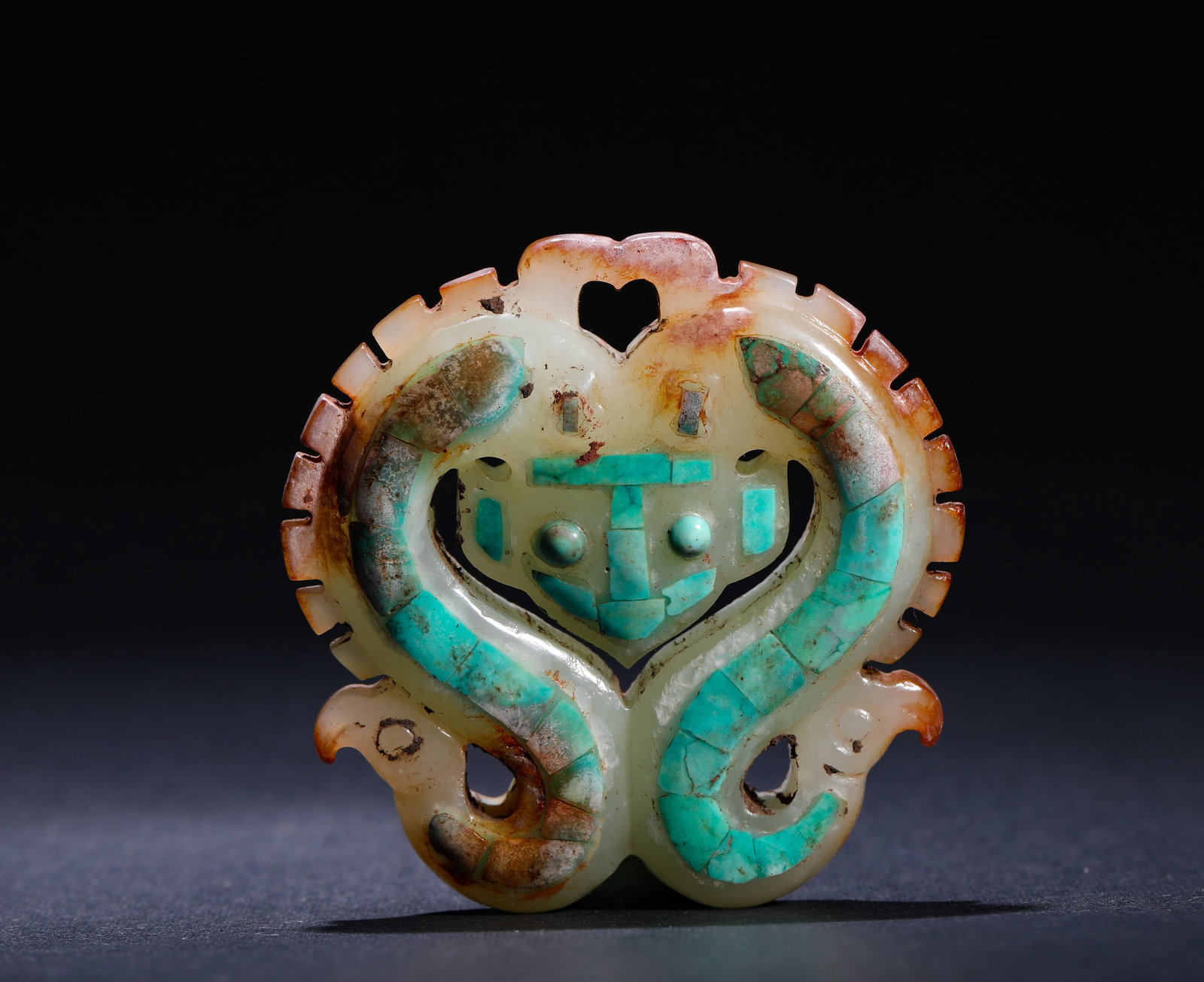 ANCIENT HAN DYNASTY JADE DISC WITH TURQUOISE AND DOUBLE DRAGON PATTERNS: H:5cm(1.97in) W:5cm(1.97in) Weight:40g(0.09lb)This is an ancient jade pendant with openwork double-dragon (double-snake) and beast-mask patterns inlaid with turquoise, featuring warm calcified jade an