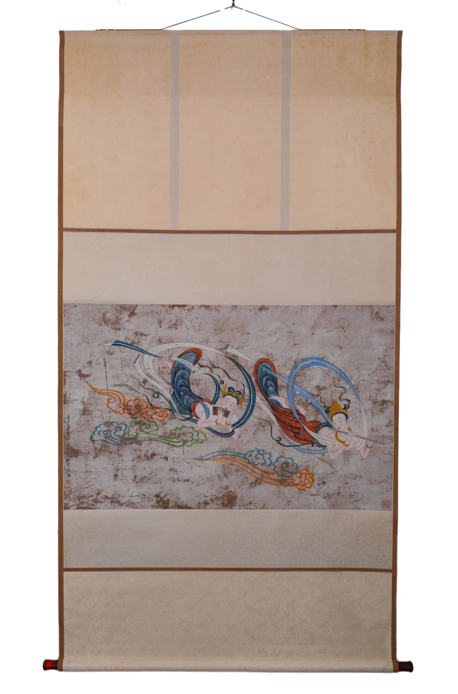 ZHANG DAQIAN (1899-1983) DUNHUANG FLYING APSARAS SCROLL: H:67cm (26.38in) W:110cm (43.31in)English: This work inherits the classic style of Dunhuang murals. It depicts two flying apsaras holding musical instruments, dancing in the sky with flowing ribbons a