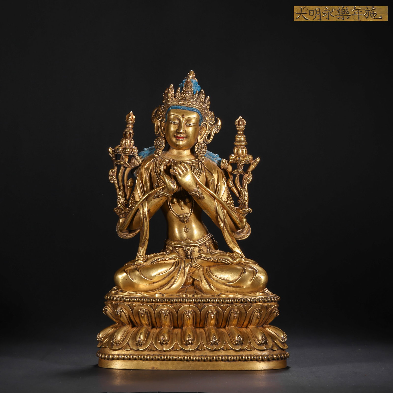 A GILDED BRONZE SEATED STATUE OF MANJUSRI BODHISATTVA FROM THE MING DYNASTY: H:28.0cm(11.02in) W:17.5cm(6.89in) Weight:3260g(7.19lb)This statue is cast in bronze and gilded. Manjushri sits in lotus position on a double lotus pedestal, wearing a treasure crown and body ornament