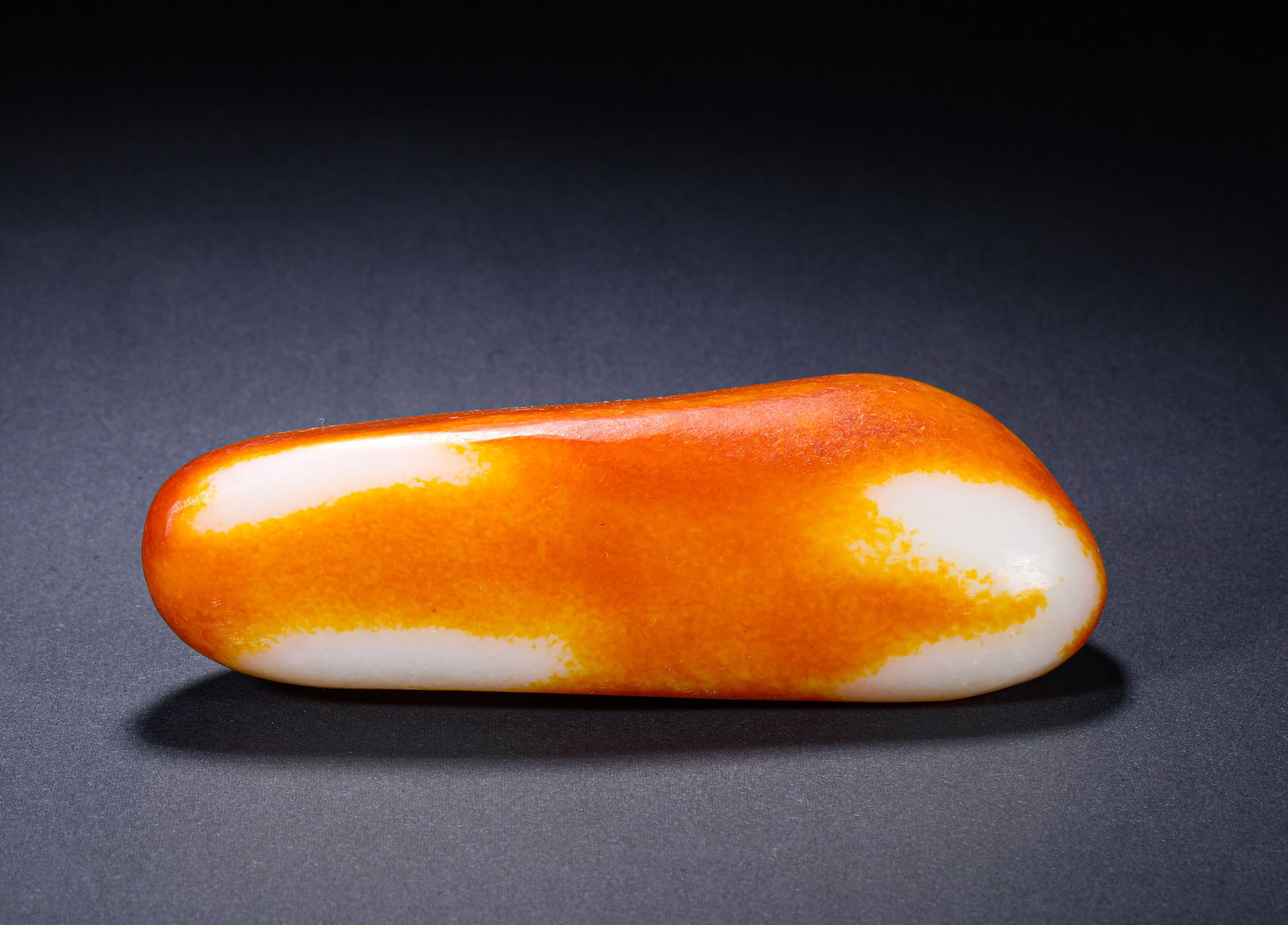 HETIAN JADE JUJUBE RED SKIN SINGLE SEED RAW STONE: H:4cm(1.57in) W:15cm(5.91in) Weight:600g(1.32lb)White jade body with exceptional greasy luster and fine texture. Exhibiting strong "fatness" (lipid feel) and gentle warmth, the white color is pure and