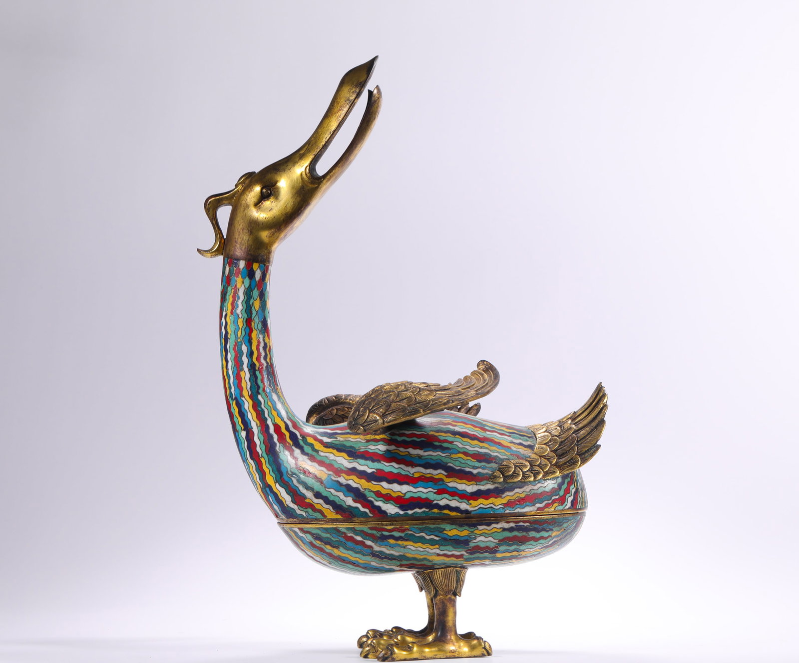 QING DYNASTY COPPER CLOISONNE ENAMEL GILDED GOOSE SHAPED LID BOX: H:45.0cm(17.72in) W:30.0cm(11.81in) Weight:5570g(12.28lb)This covered box is a masterpiece of the craftsmanship of the Qing Dynasty Imperial Workshop. Made of fine bronze with full-body cloisonné ena