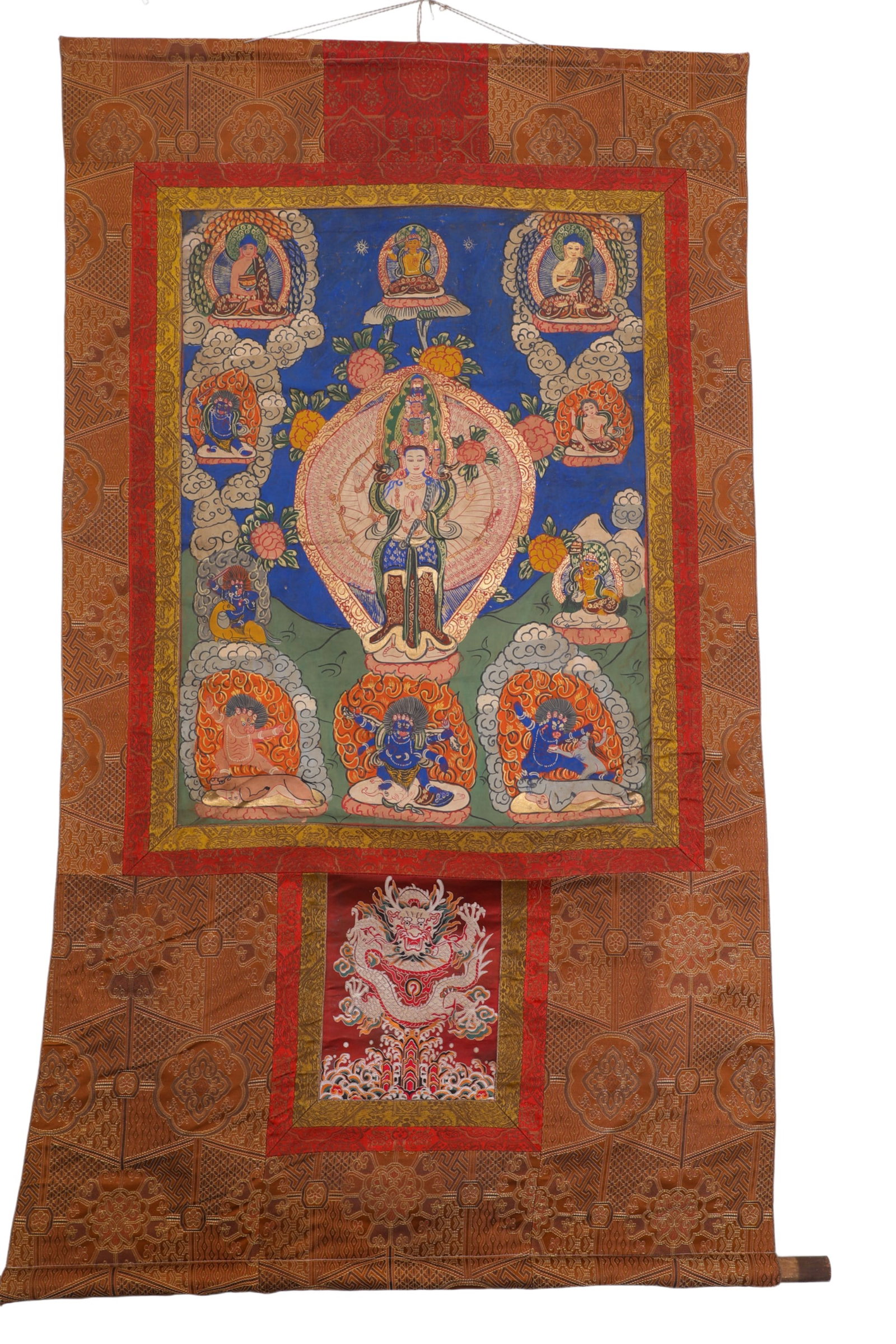 QING DYNASTY GUANYIN THANGKA: H:78cm (30.71in) W:60cm (23.62in)The main deity is Thousand-Handed Avalokite?vara, with complete thousand-arms halo. The painting is surrounded by three Buddhas, attendant Bodhisattvas and wrathful gu