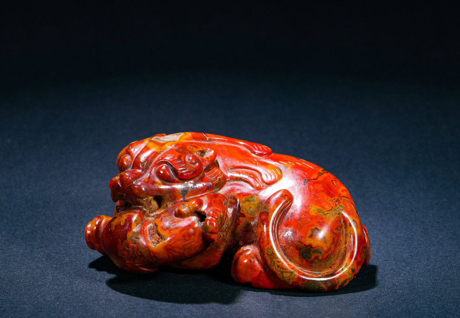 RED AGATE CARVED PI XIU FROM THE WARRING STATES PERIOD: H:4cm (1.57in) W:8cm (3.15in) Weight:180g (0.40lb) This is a auspicious beast (Pixiu) handlepiece carved from Warring States Red Agate, featuring a gorgeous color combination and exquisite craftsmansh