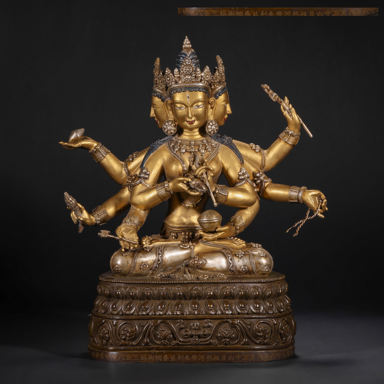 A GILDED BRONZE SEATED STATUE OF THE HOLY MOTHER OF THE QING DYNASTY: H:38.0cm(14.96in) W:29.0cm(11.42in) Weight:6300g(13.89lb)This statue is cast in bronze with partial gilding. Ushnisha Vijaya sits in lotus position on a lotus pedestal, in a three-faced, eight-armed f