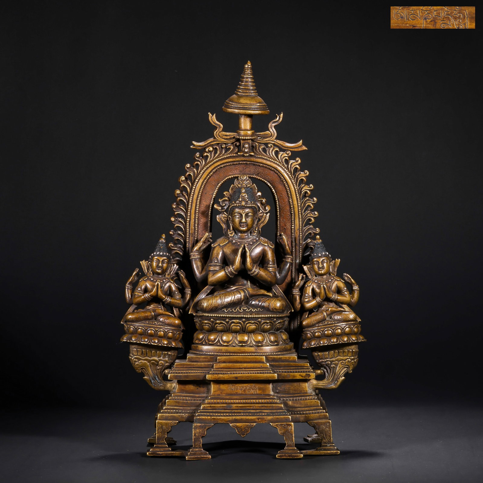 A BRONZE STATUE OF GUANYIN WITH FOUR ARMS FROM THE QING DYNASTY: H:36.0cm(14.17in) W:21.5cm(8.46in) Weight:4400g(9.70lb)This statue is cast in bronze. The main figure is Four-Armed Guanyin, sitting in lotus position on a lotus pedestal, wearing a treasure crown wit