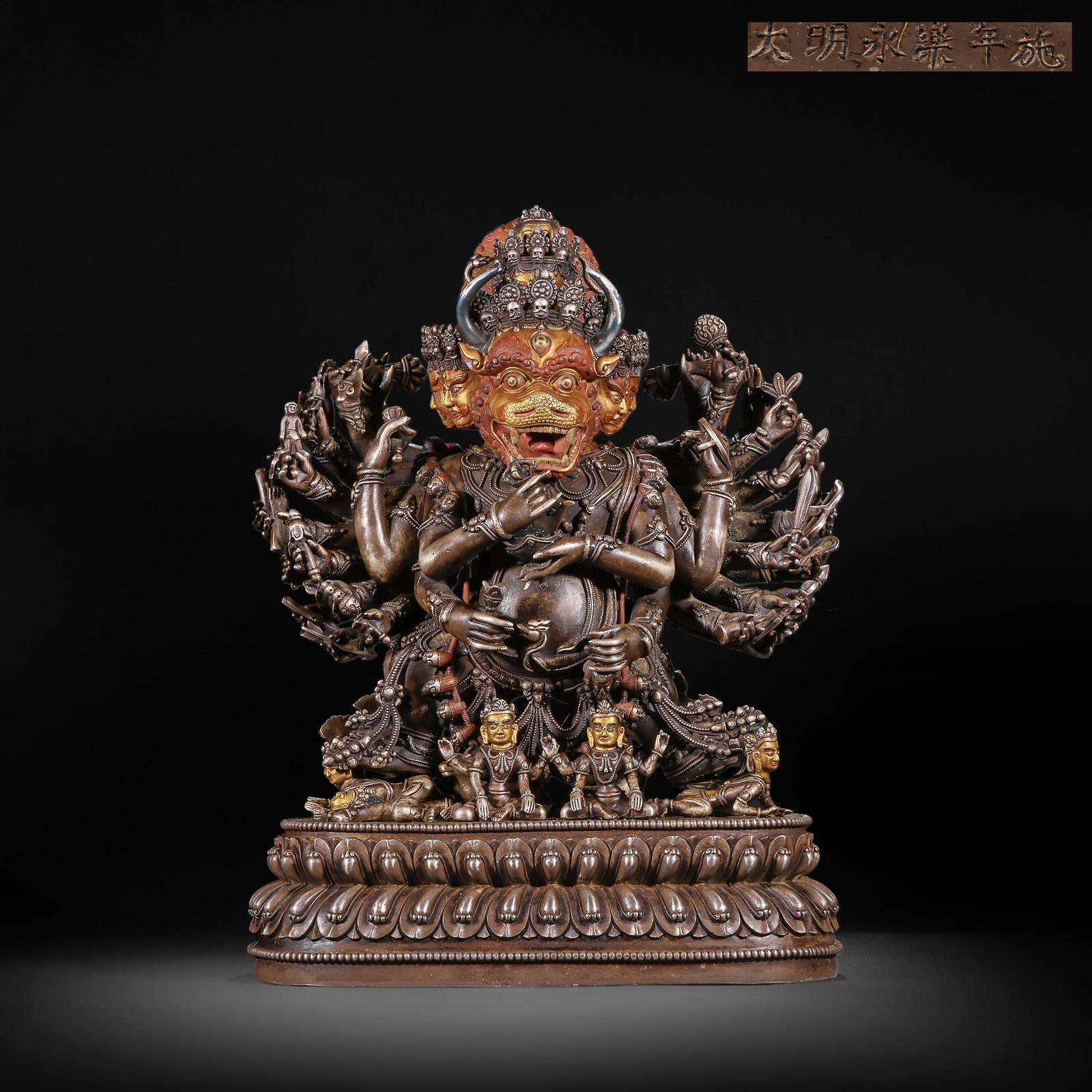 A BRONZE GILDED AND SILVER-INLAID VAJRA STATUE FROM THE MING DYNASTY: H:33.0cm(12.99in) W:23.5cm(9.25in) Weight:9400g(20.72lb)This statue is cast in copper with partial gilding, depicting Yamantaka, a prominent deity in Tibetan Buddhist Tantrism, symbolizing subduing ob