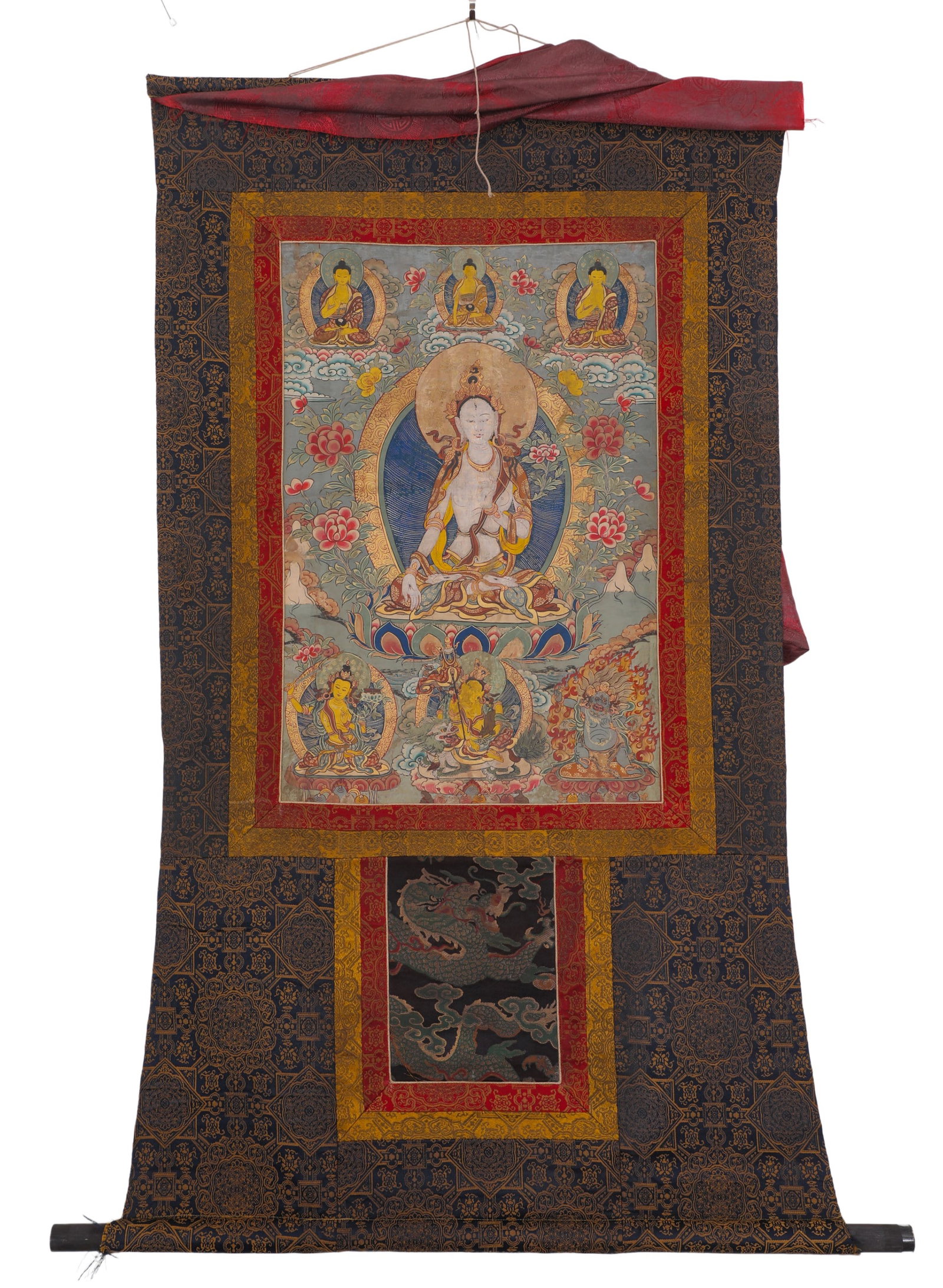 WHITE TARA THANGKA OF THE QING DYNASTY: H:68cm (26.77in) W:46cm (18.11in)The main deity is White Tara, with pure white body and merciful face, sitting on lotus throne in meditative posture. The painting is surrounded by three Buddhas on upp