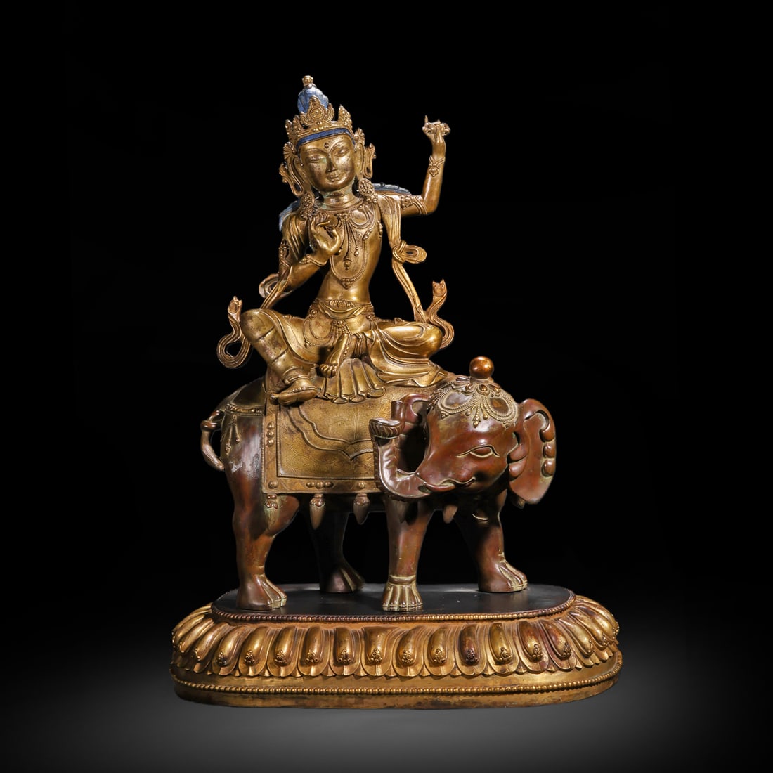 QING DYNASTY GILDED BRONZE STATUE OF BODHISATTVA SAMANTABHADRA RIDING AN ELEPHANT: H:60cm(23.62in) W:42cm(16.54in) Weight:20050g(44.20lb)This statue is cast in bronze and gilded. Samantabhadra Bodhisattva sits in a relaxed posture on a six-tusked white elephant, wearing a precious c