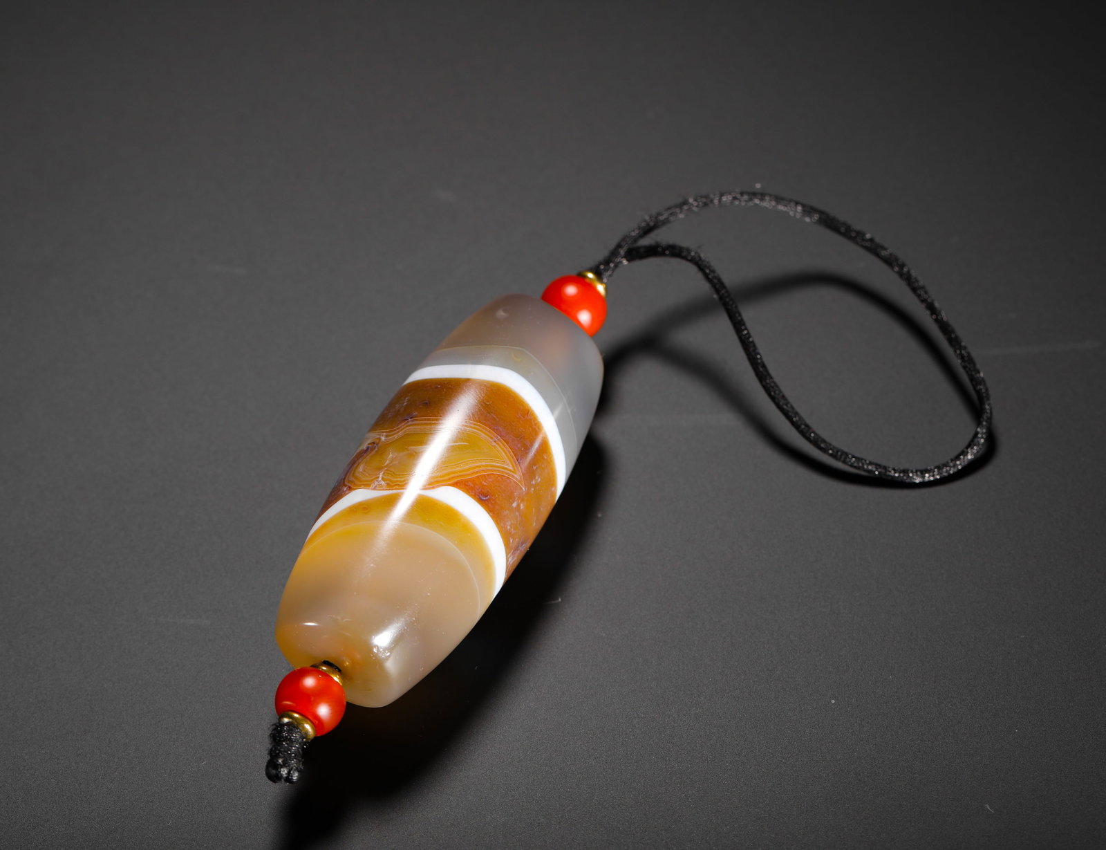 QING DYNASTY SILK AGATE BEAD PENDANT: H:7cm(2.76in)D:3cm(1.18in)Weight:100g(0.22lb)These objects were worn by literati in the Qing Dynasty. The heaven bead-shaped agate symbolized protection and good fortune, reflecting the exquisite jade