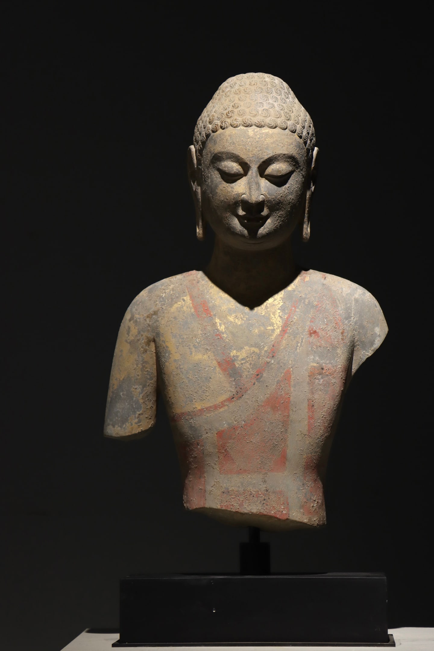 A HALF-LENGTH STONE BUDDHA FROM THE NORTHERN QI DYNASTY (1 of 9)