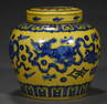 A QING DYNASTY YELLOW GROUND BLUE AND WHITE LION GRAIN