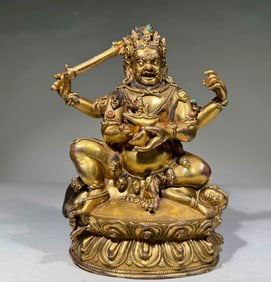 QING DYNASTY GILT BRONZE FOUR-ARMED MAGALA
