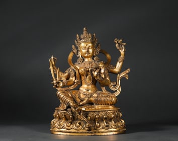 A bronze gilt four-arm Guanyin, Ming Dynasty, China
