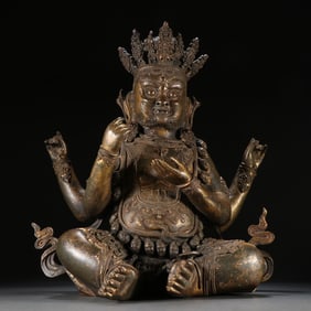 A MING DYNASTY GILDED FOUR-ARMED MAHAKALA
