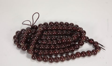ONE HUNDRED AND EIGHT BLOOD AMBER BUDDHIST BEADS FROM THE MING DYNASTY