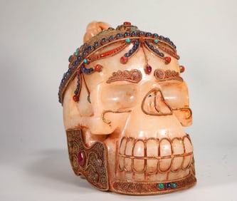 CRYSTAL SKULL INLAID WITH GEMSTONES FROM THE QING DYNASTY