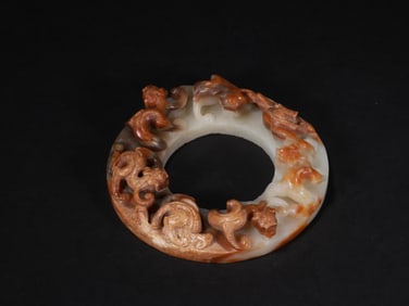 A JADE DISC WITH DRAGON PATTERNS FROM THE HAN DYNASTY