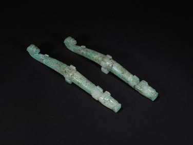 A PAIR OF HAN DYNASTY DRAGON-SHAPED HOOKS