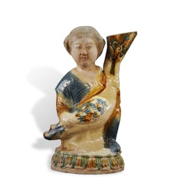 Tang Dynasty Tri-color female figurine holding a duck-shaped ewer with blue glaze