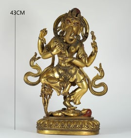 A MING DYNASTY GILDED BRONZE GOD OF WEALTH WITH AN ELEPHANT TRUNK