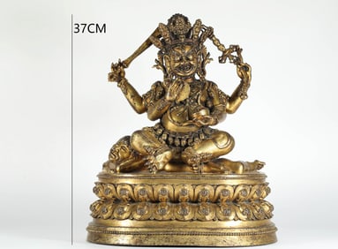 A MING DYNASTY GILDED BRONZE FOUR-ARMED MAGARA
