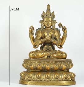 A MING DYNASTY GILT BRONZE FOUR-ARMED BODHISATTVA
