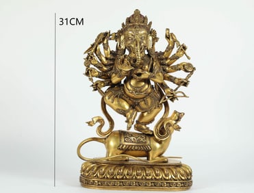 A MING DYNASTY GILDED BRONZE GOD OF WEALTH WITH AN ELEPHANT TRUNK