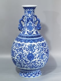 QING DYNASTY BLUE AND WHITE LOTUS AND EIGHT TREASURES PATTERN DOUBLE-EARED VASE