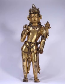 A QING DYNASTY GILT BRONZE STATUE OF GUANYIN HOLDING A LOTUS