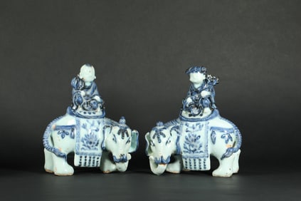 A PAIR OF BLUE AND WHITE PORCELAIN FIGURES OF CHILDREN RIDING ELEPHANTS FROM THE YUAN DYNASTY