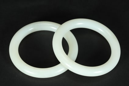 A PAIR OF WHITE JADE BRACELETS FROM THE QING DYNASTY