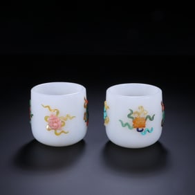 A PAIR OF QING DYNASTY HETIAN JADE CUPS INLAID WITH EIGHT TREASURES