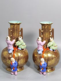 A PAIR OF QING DYNASTY PURPLE-GOLD GLAZED, GOLD-PAINTED, FAMILLE ROSE VASES WITH THREE HANDLES