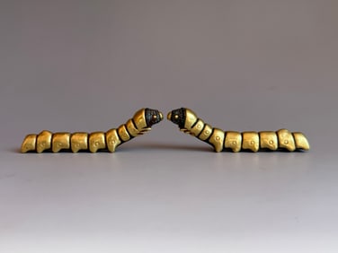 A PAIR OF GILT BRONZE SILKWORMS FROM THE TANG DYNASTY
