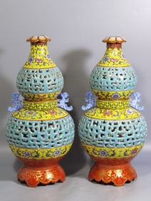 A PAIR OF QING DYNASTY ENAMEL GOURD-SHAPED REVOLVING VASES