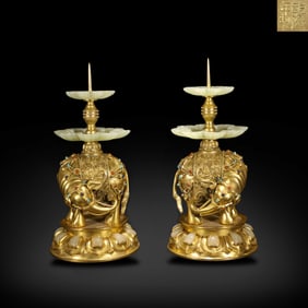 Qing Dynasty Qianlong period, A pair of gilt-bronze candlesticks inlaid with various treasures and