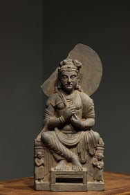 A Gandhara-style stone-carved seated Buddha statue