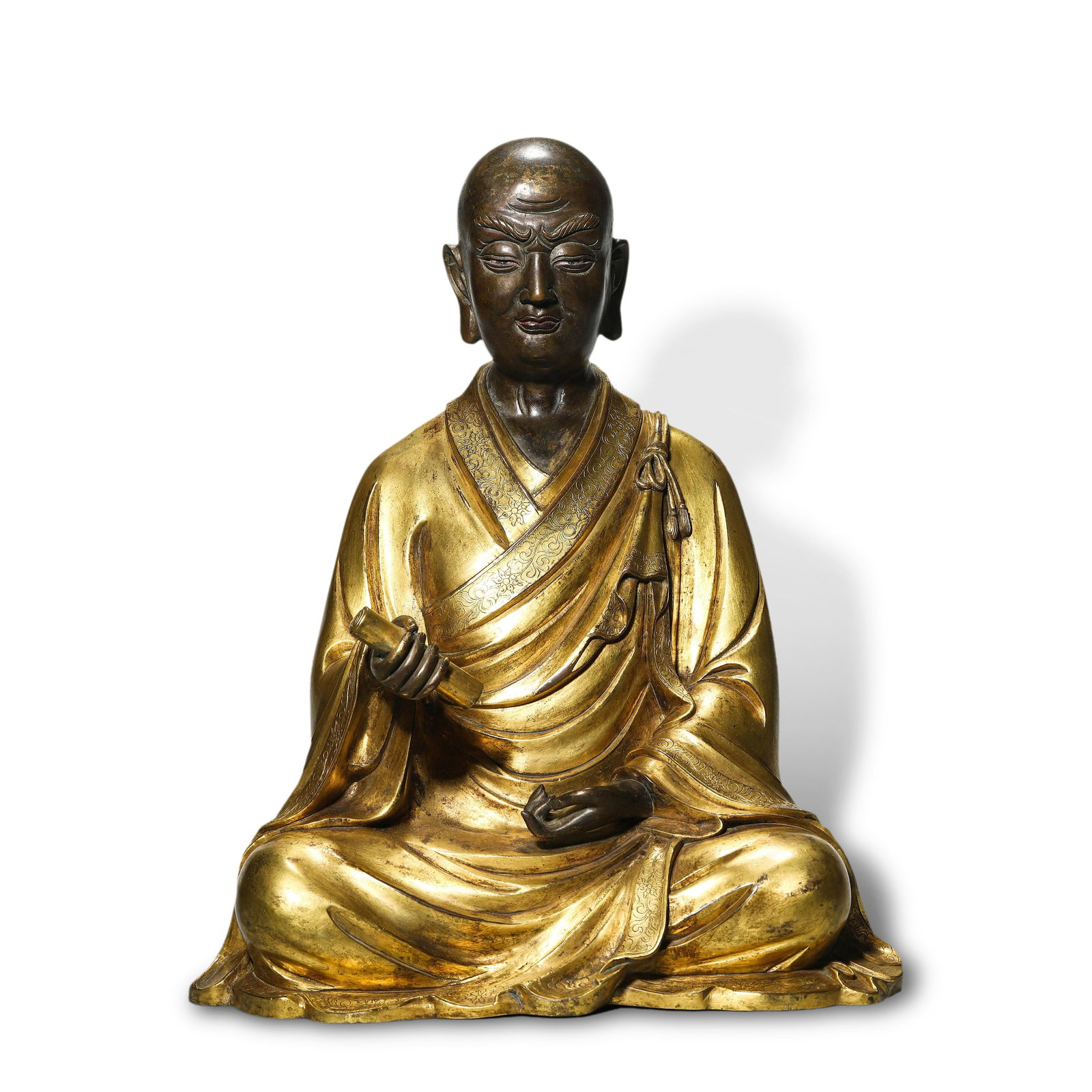 Ming Dynasty Gilt-bronze Arhat statue holding a scroll: Name Ming Dynasty Gilt-bronze Arhat statue holding a scroll Dimensions H:38cm W:31cm Condition Additional photographs and condition reports are available upon request as a courtesy t