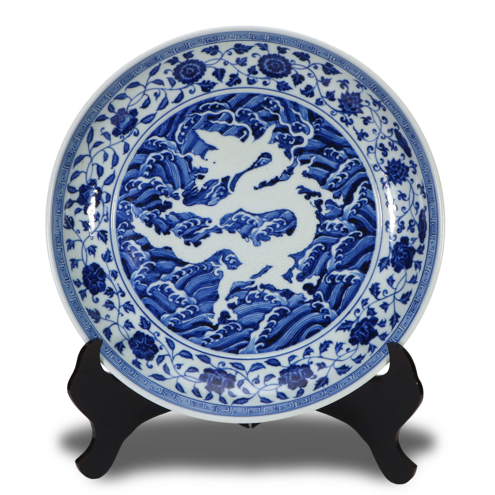 Ming Dynasty Yongle period, Large blue-and-white plate with interlocking floral, reserved sea wave: Name Ming Dynasty Yongle period, Large blue-and-white plate with interlocking floral, reserved sea wave motifs and incised dragon patterns Dimensions D:40.4cm Condition Additional ph