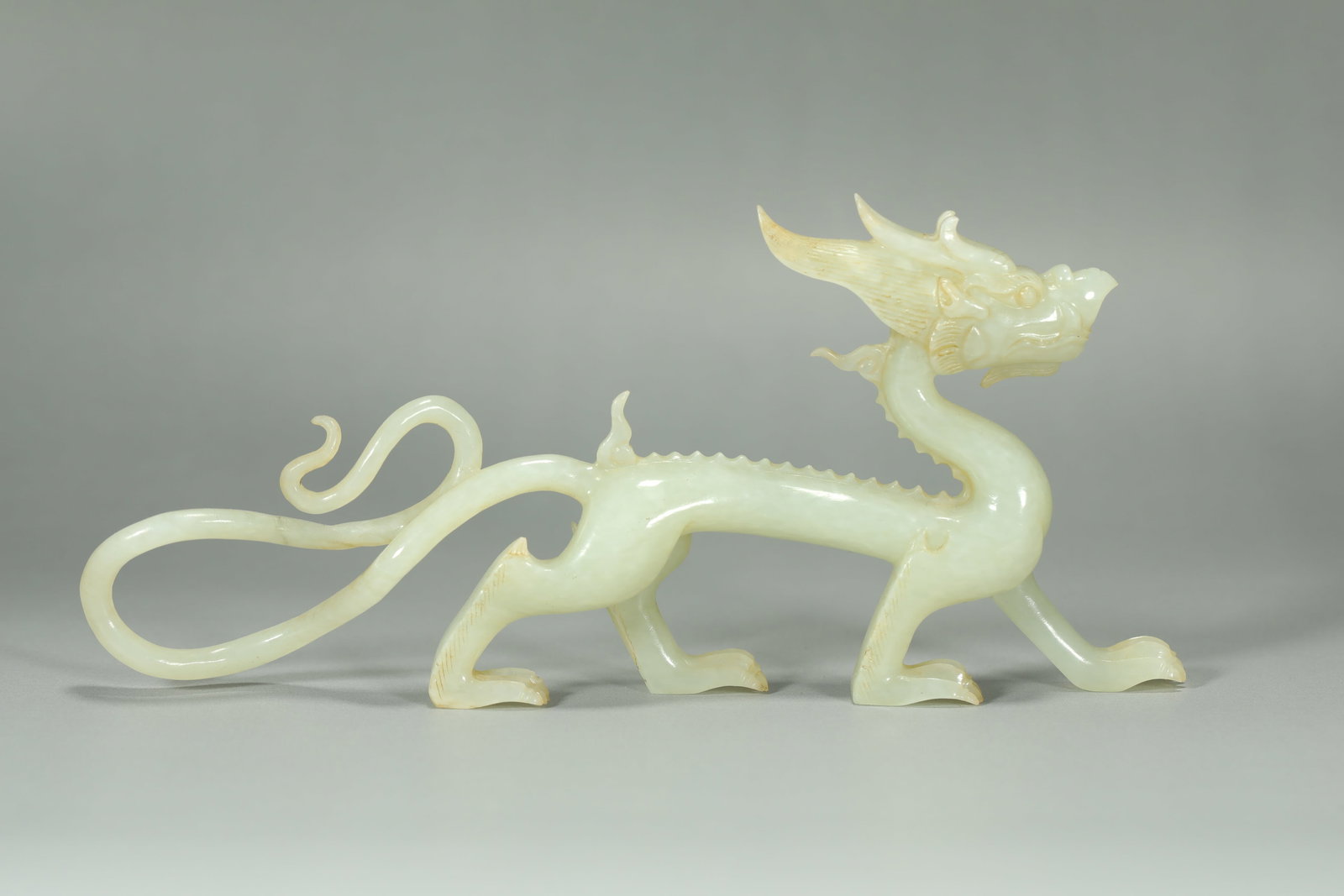 MING DYNASTY WHITE JADE DRAGON: Name MING DYNASTY WHITE JADE DRAGON Dimensions H:8CM L:18CM Condition Additional photographs and condition reports are available upon request as a courtesy to our clients. Any condit