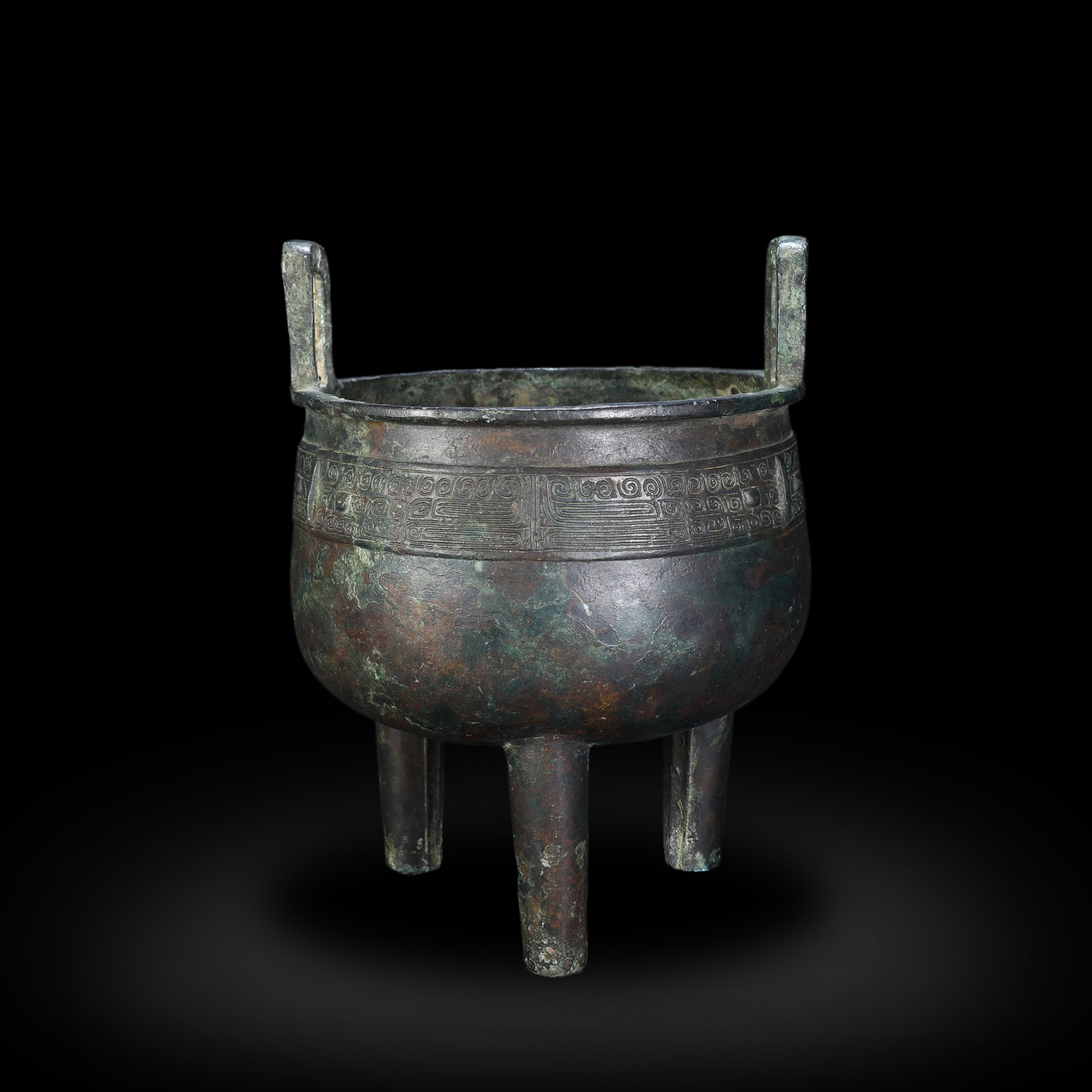 Shang Dynasty Ding Tripod with Taotie Mask Pattern: Name Shang Dynasty Ding Tripod with Taotie Mask Pattern Dimensions H:22.5cm W:16.5cm Condition Additional photographs and condition reports are available upon request as a courtesy t