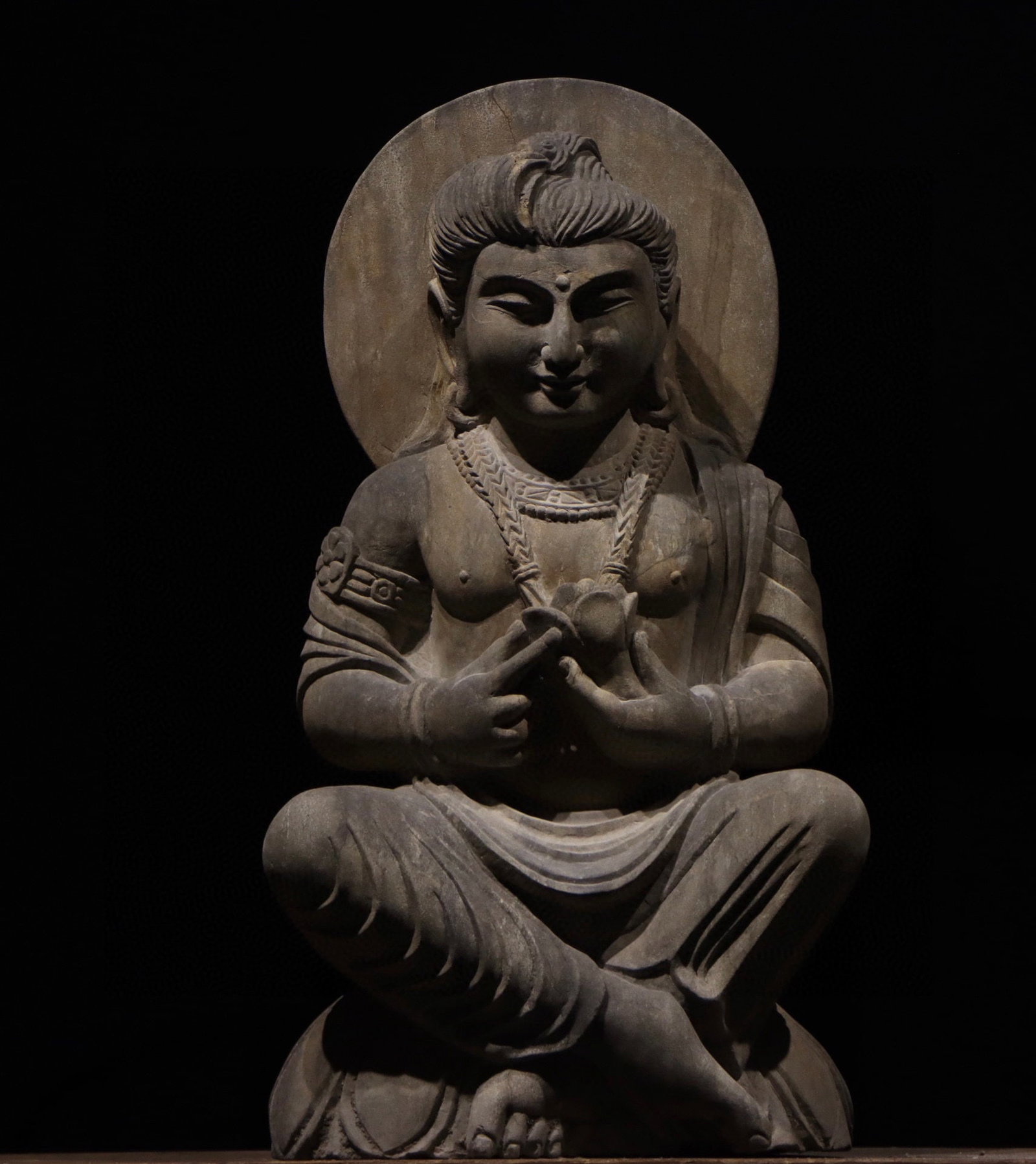 A Gandhara-style stone-carved seated Buddha statue (1 of 8)